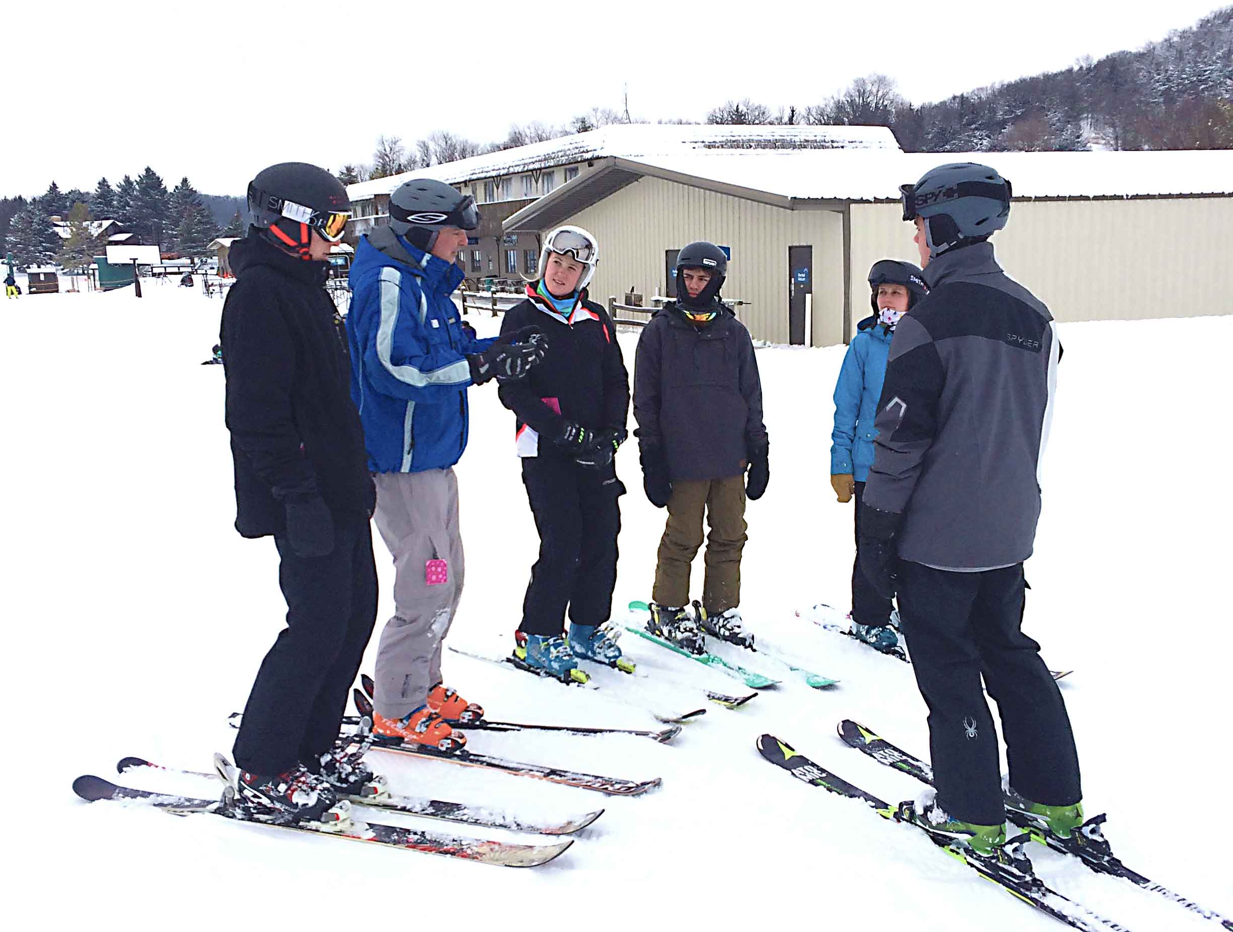 Ski instructor talking to students